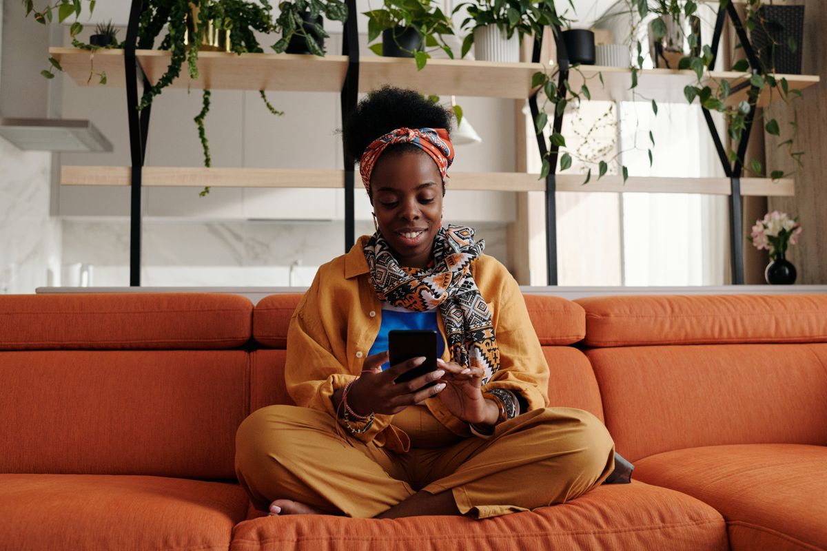 A member holding a phone with a payment app open