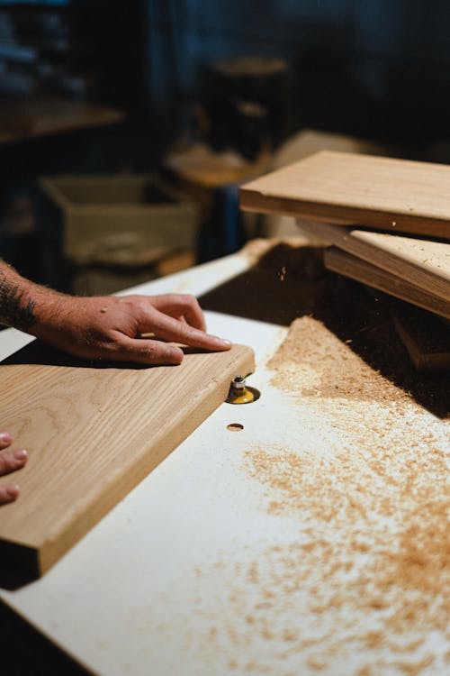 Carpenter Shaping Wood Plank 