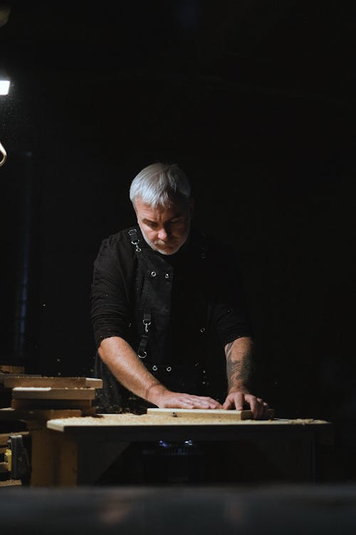 Serious Craftsman Working on Workbench 