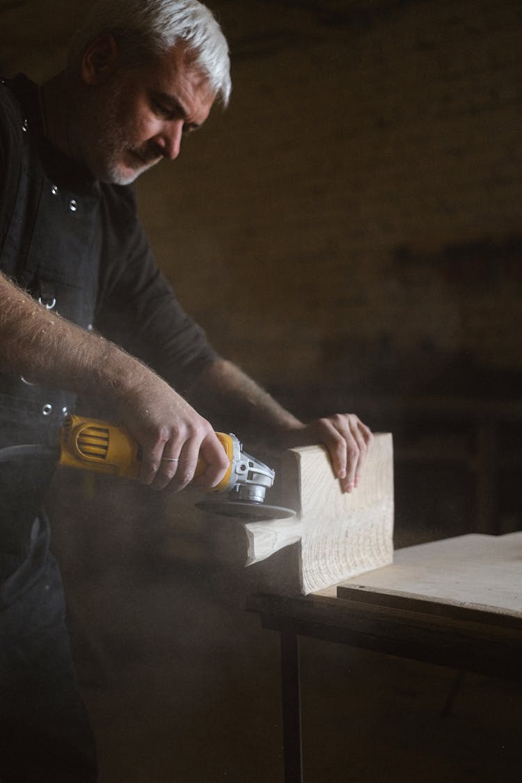 Focused Craftsman Using Angle Grinder