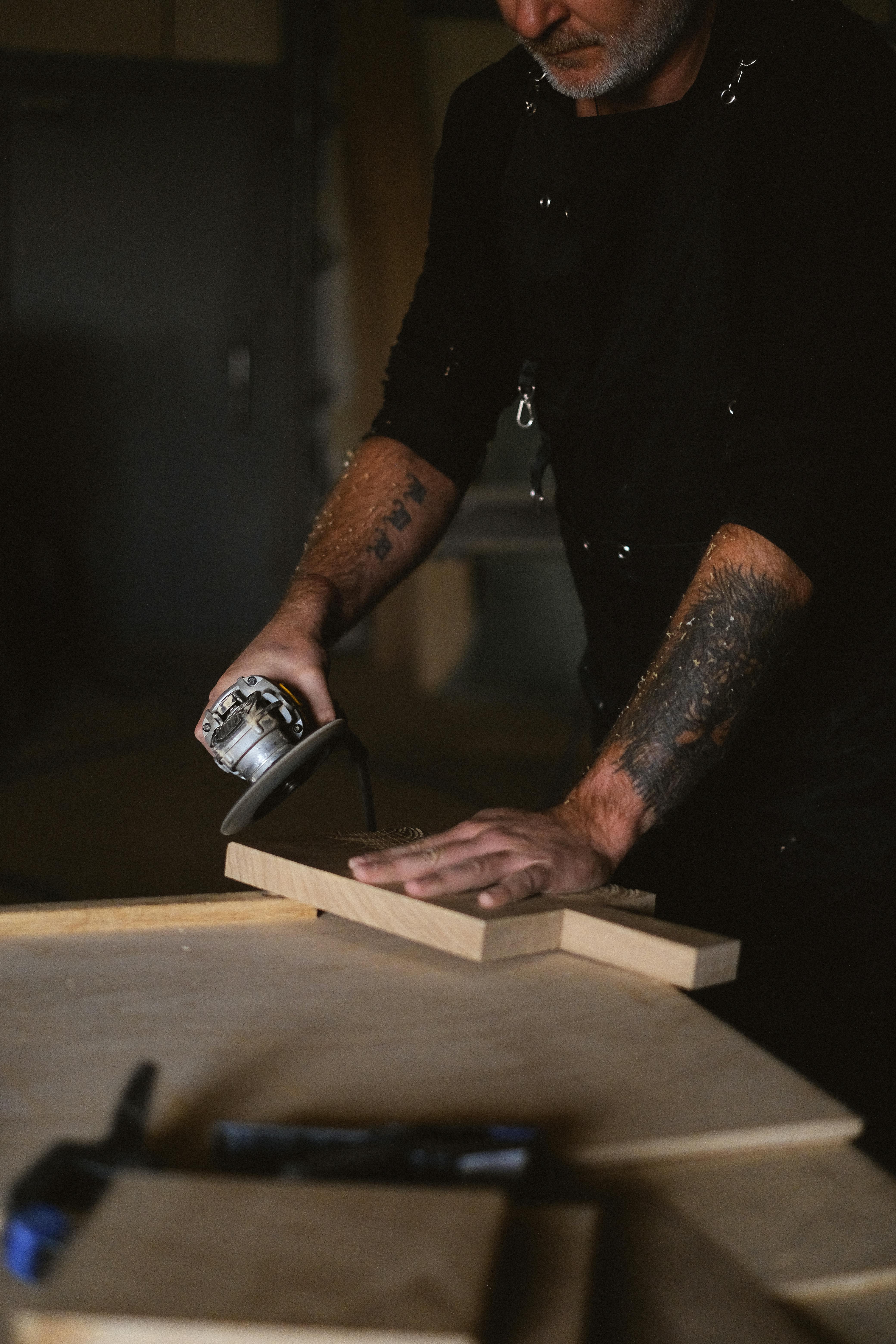 crop woodworker grinding wooden plank