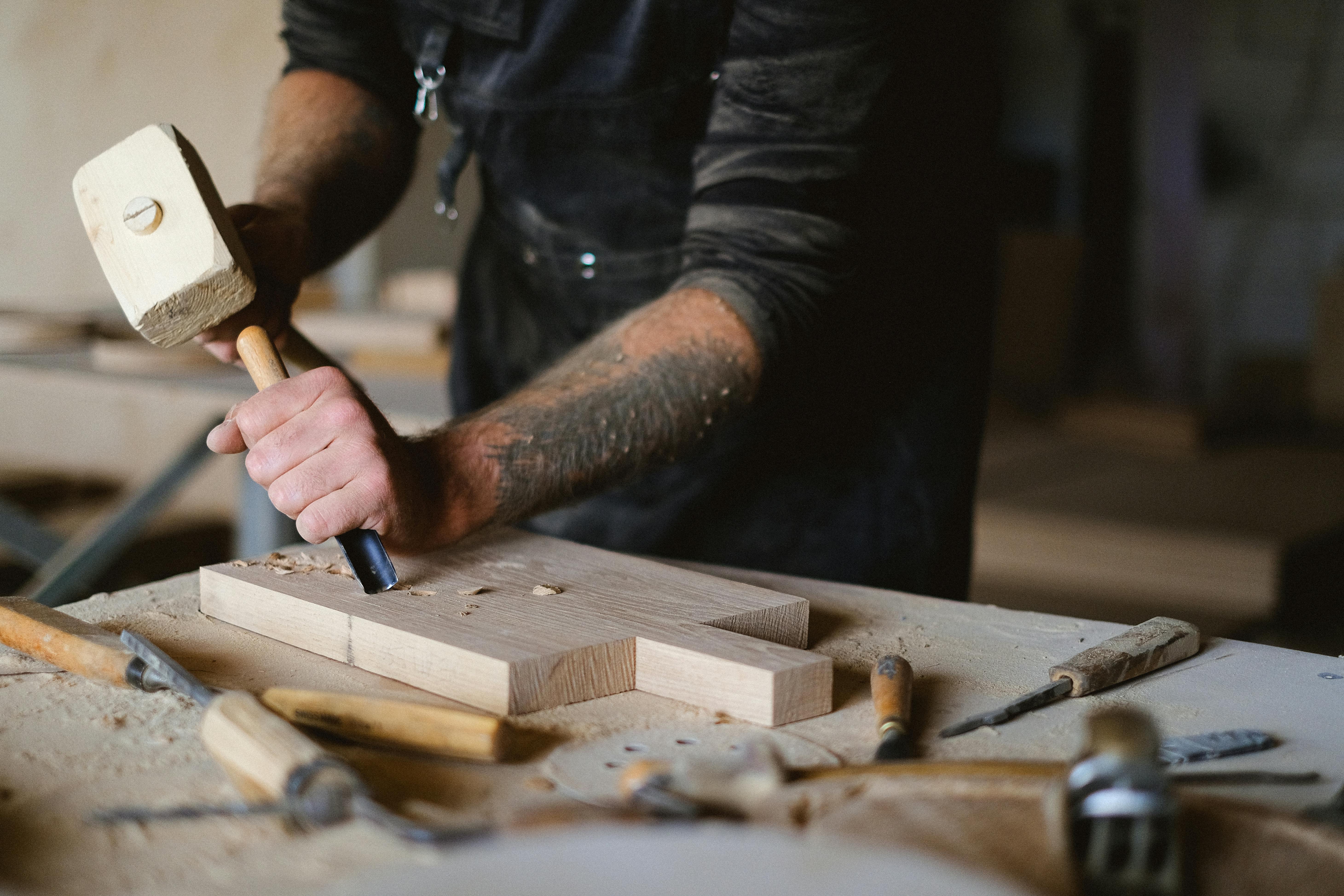 crop carpenter with chisel carving wood