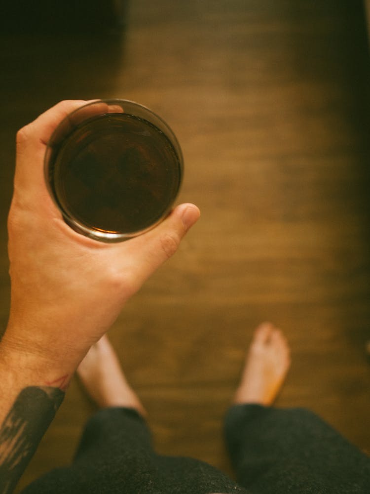 Crop Anonymous Man Drinking Herbal Tea At Home