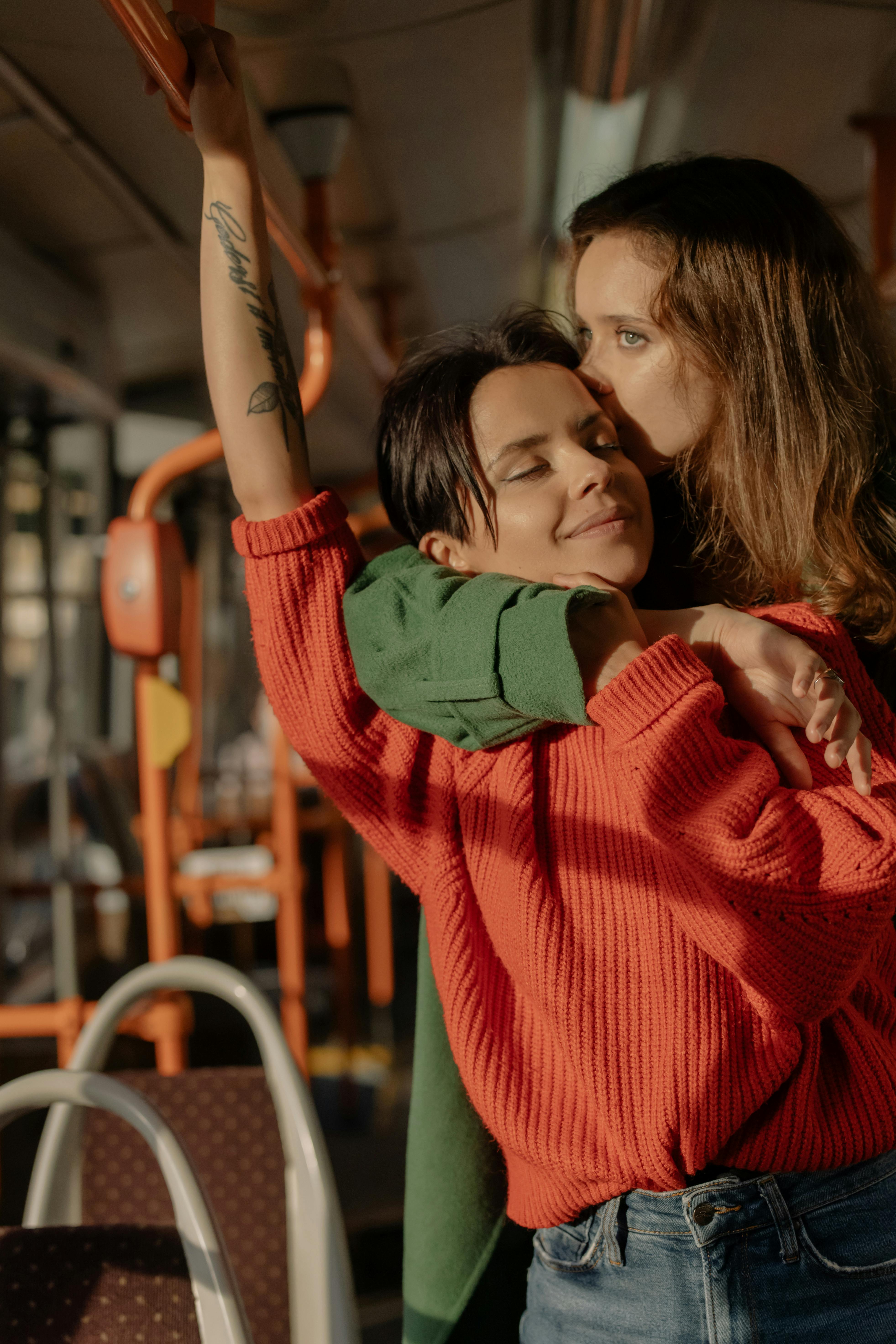 embracing couple standing in bus