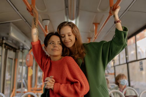 Free Women Holding Hands Standing in a Train  Stock Photo