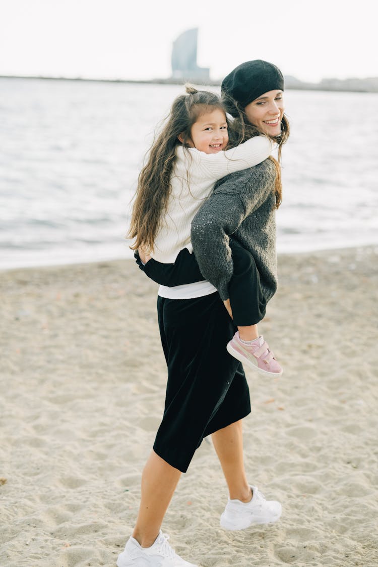 Mother Carrying Her Daughter In Her Back