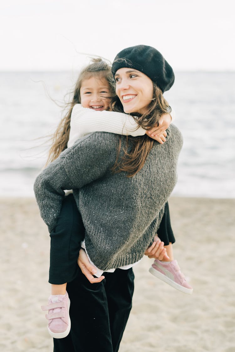 Woman In Gray Sweater Carrying Her Child