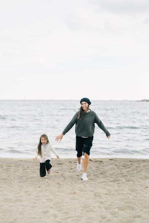 Mother Chasing Her Daughter at the Beach