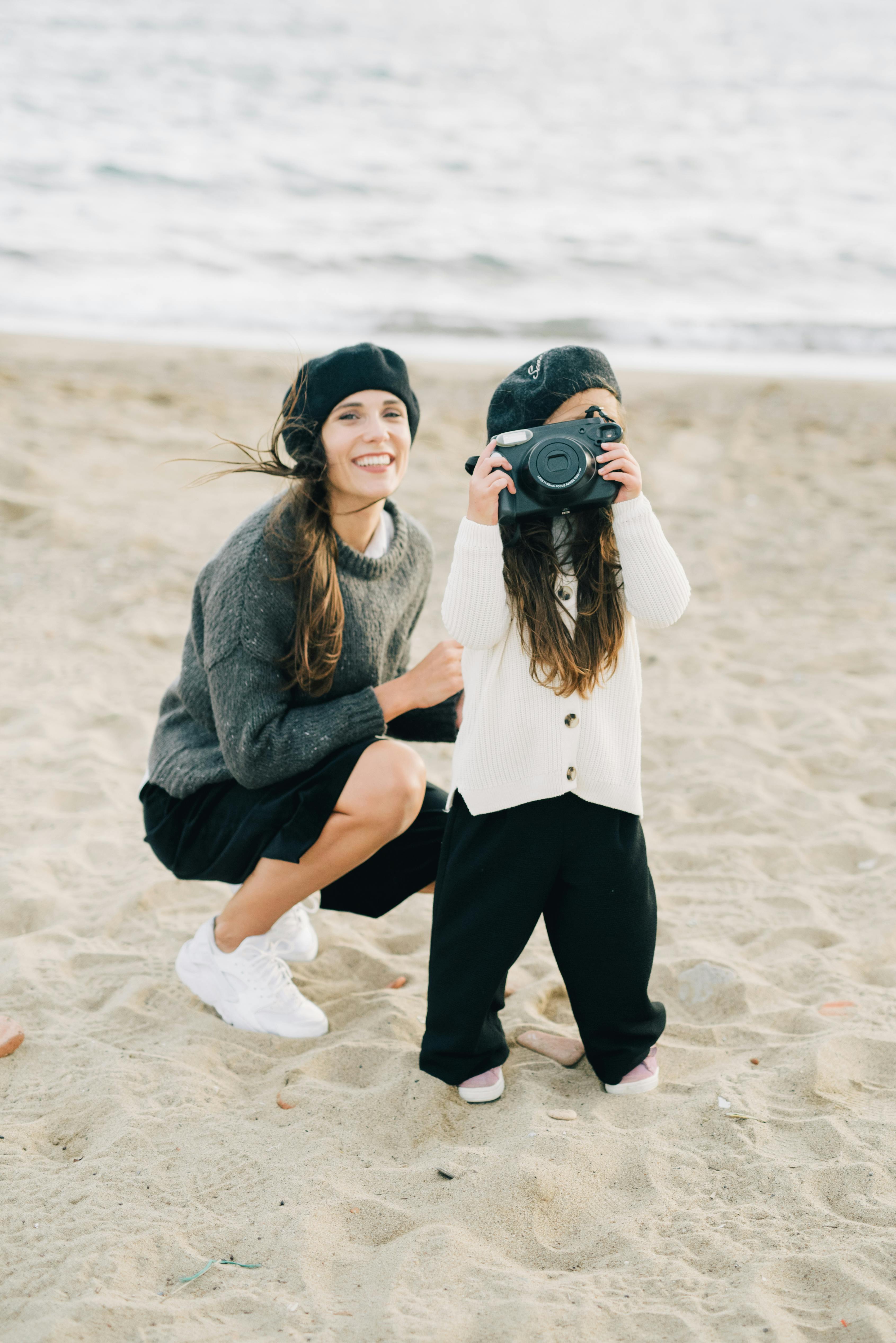 a woman spending time with her daughter at the beach