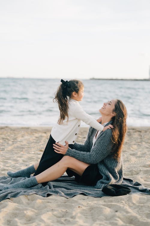 Mother Playing with Her Daughter at the Beach