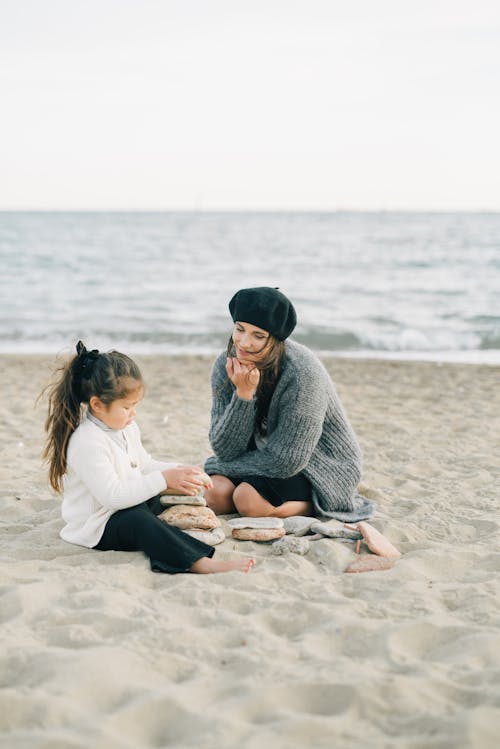Free Mother and Daughter Sitting on Sand Stock Photo