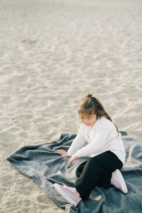 Girl Sitting on a Blue Blanket