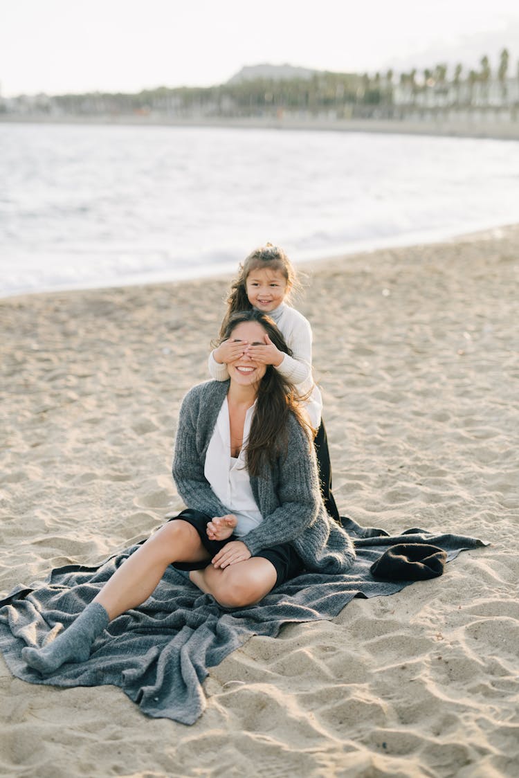 A Girl Covering Her Mother Eyes