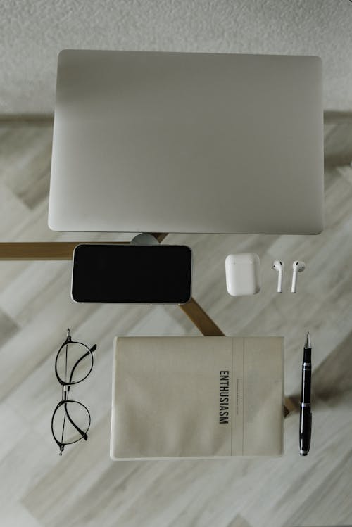Free Wireless Gadgets on Glass Desk with Notebook and Pen
 Stock Photo