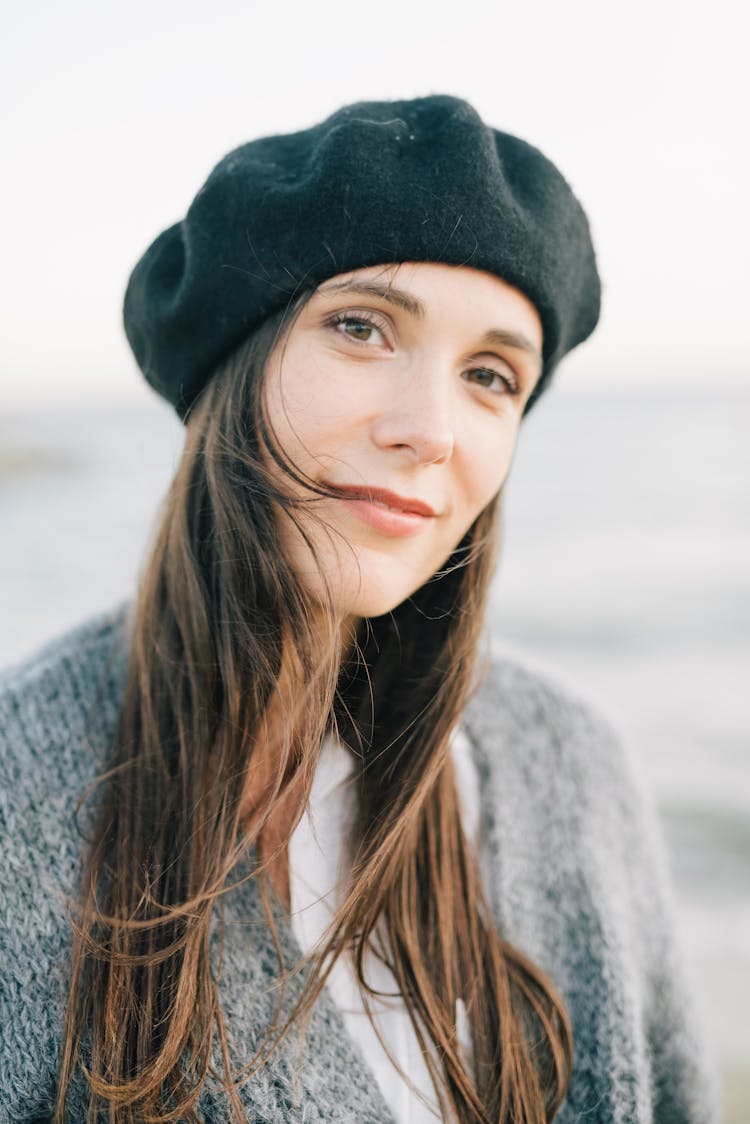 Woman With Long Hair In Gray Sweater Wearing Black Knit Cap