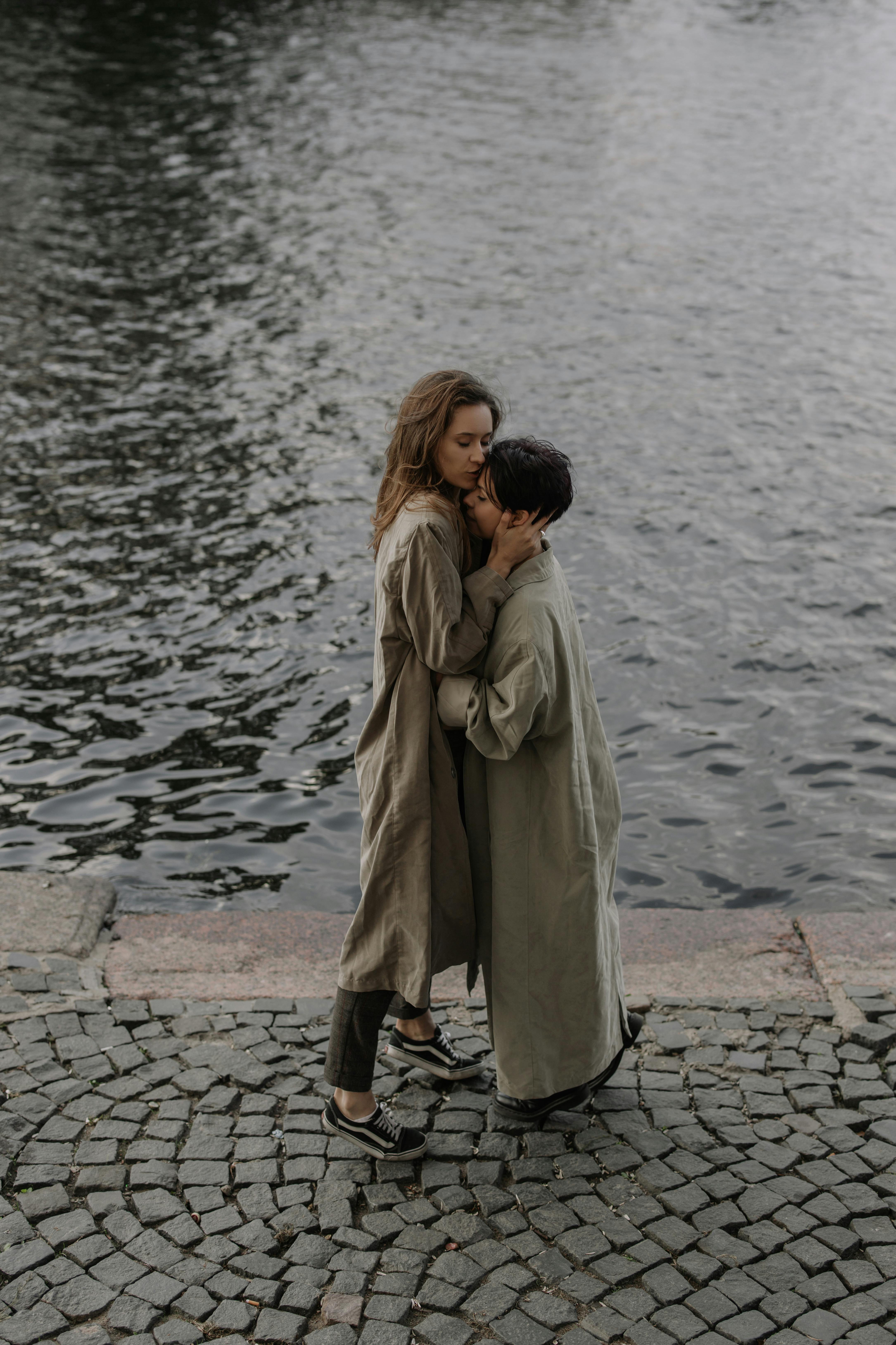 two women embracing by the river