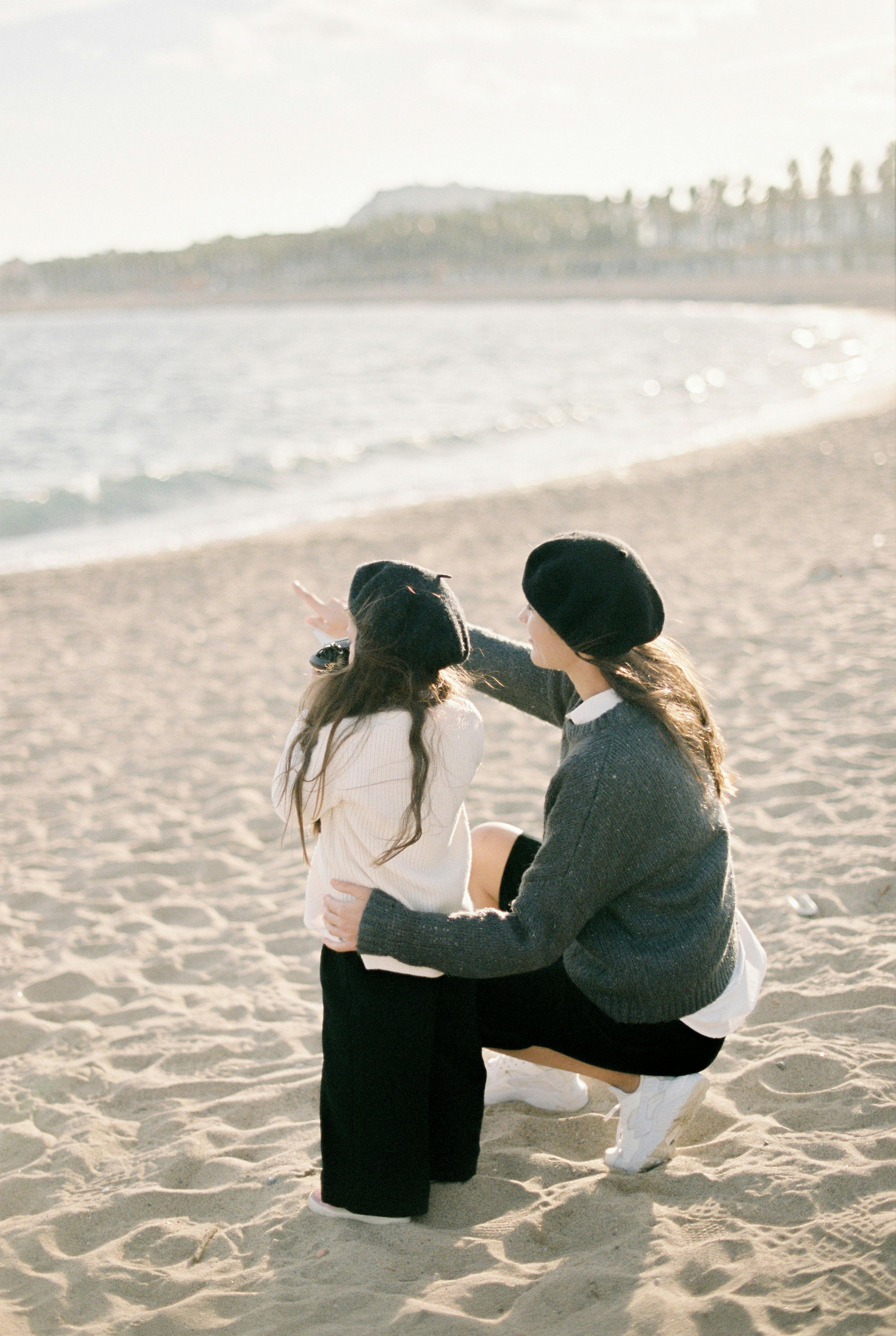 a woman and a kid at the beach