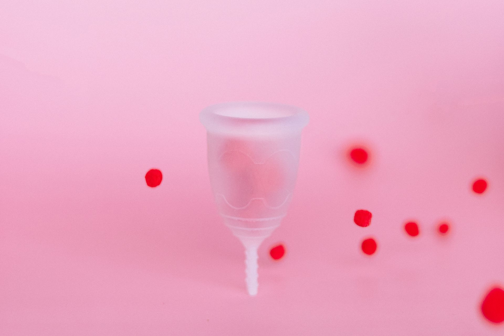 Silicone Menstruation Cup on Pink Surface