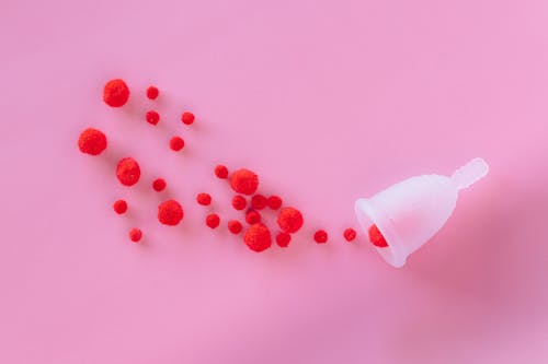 Red and White Round Beads on White Surface