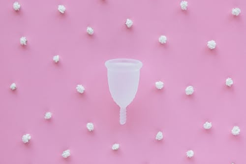 White Plastic Cup on Pink and White Polka Dot Textile