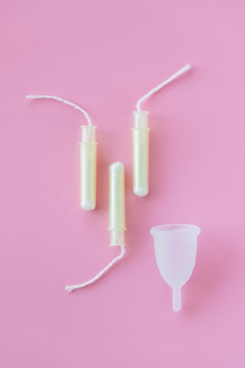 Free Tampons near the White Menstrual Cup  Stock Photo