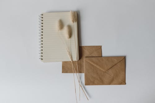 A Notebook and Envelope on the Table 