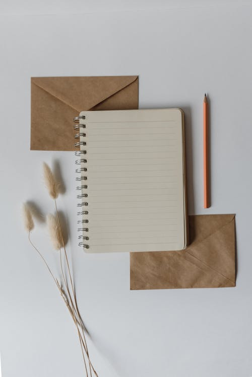 Free A Notebook and Pencil on the Table  Stock Photo