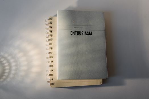 Spiral notepad with the word 'Enthusiasm' on a white background, perfect for motivation themes.