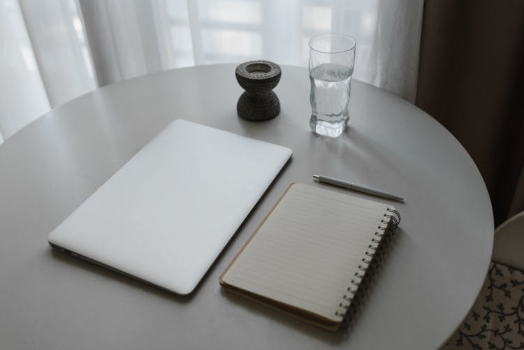 Notebook Beside A Laptop