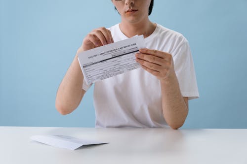 Free Man in White T-shirt Holding HIV/AIDS Paper Form Stock Photo