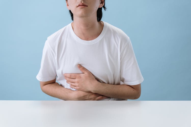 Man In White Shirt Suffering From A Stomach Pain