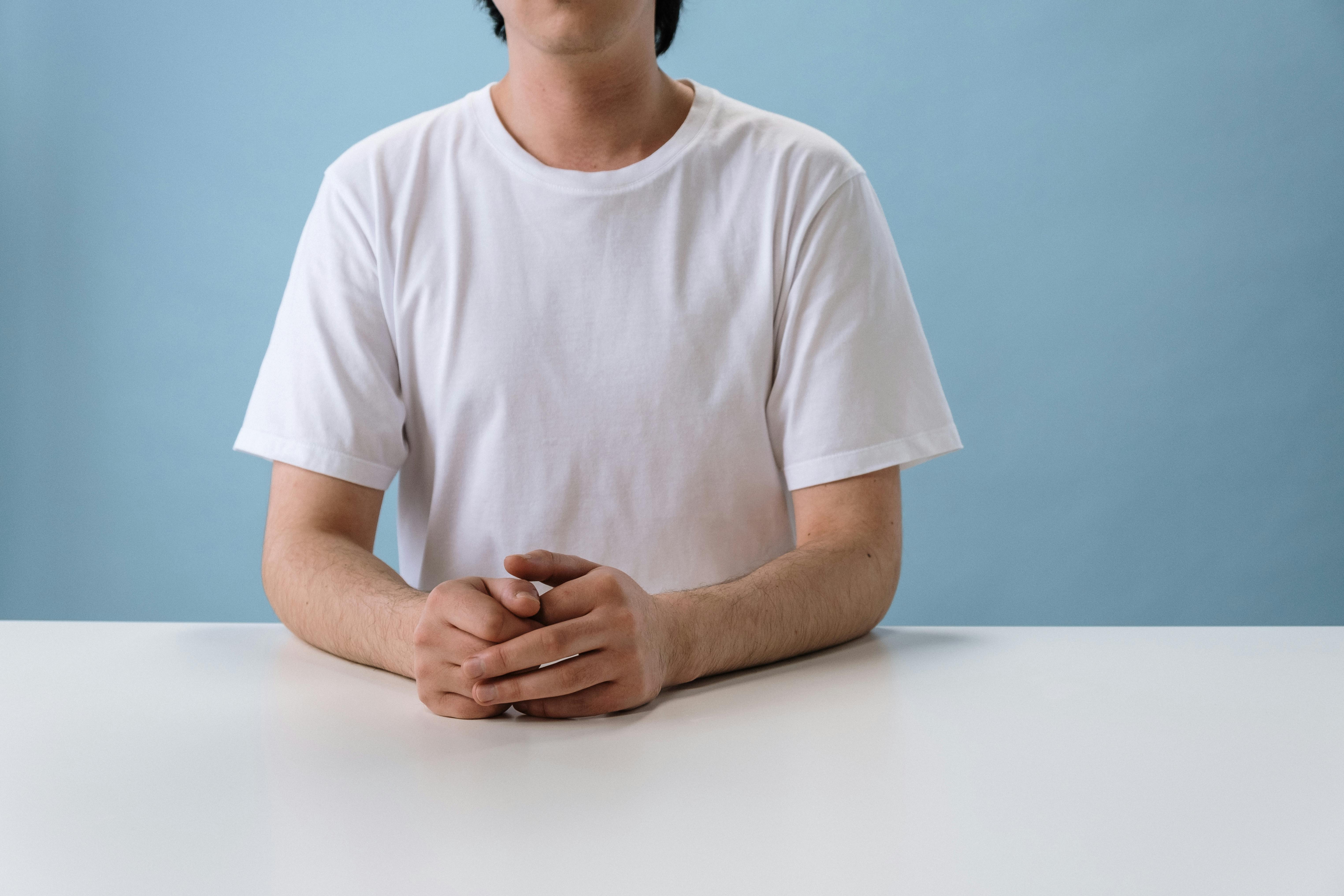 Neatly Folded White Crew Neck T-shirt Over Other Shirts · Free Stock Photo