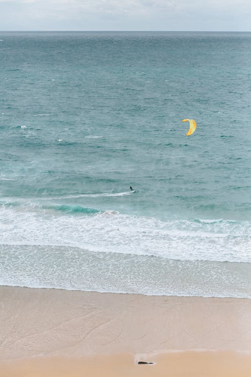 A Person Surfing on Sea Waves