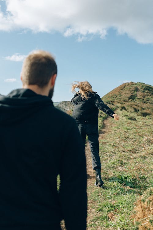 Two People Hiking on a Hill