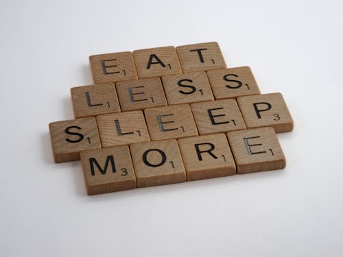 Brown Wooden Scrabble Blocks on White Surface