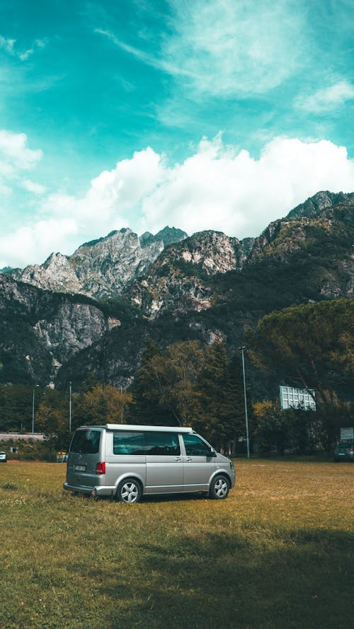 Van Parked on the Grass Near the Mountain