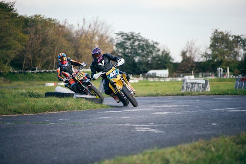 Men Driving Motorcycles on the Race Track