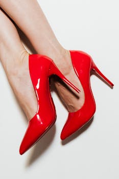 Sleek red high heels elegantly showcased on a clean white background.