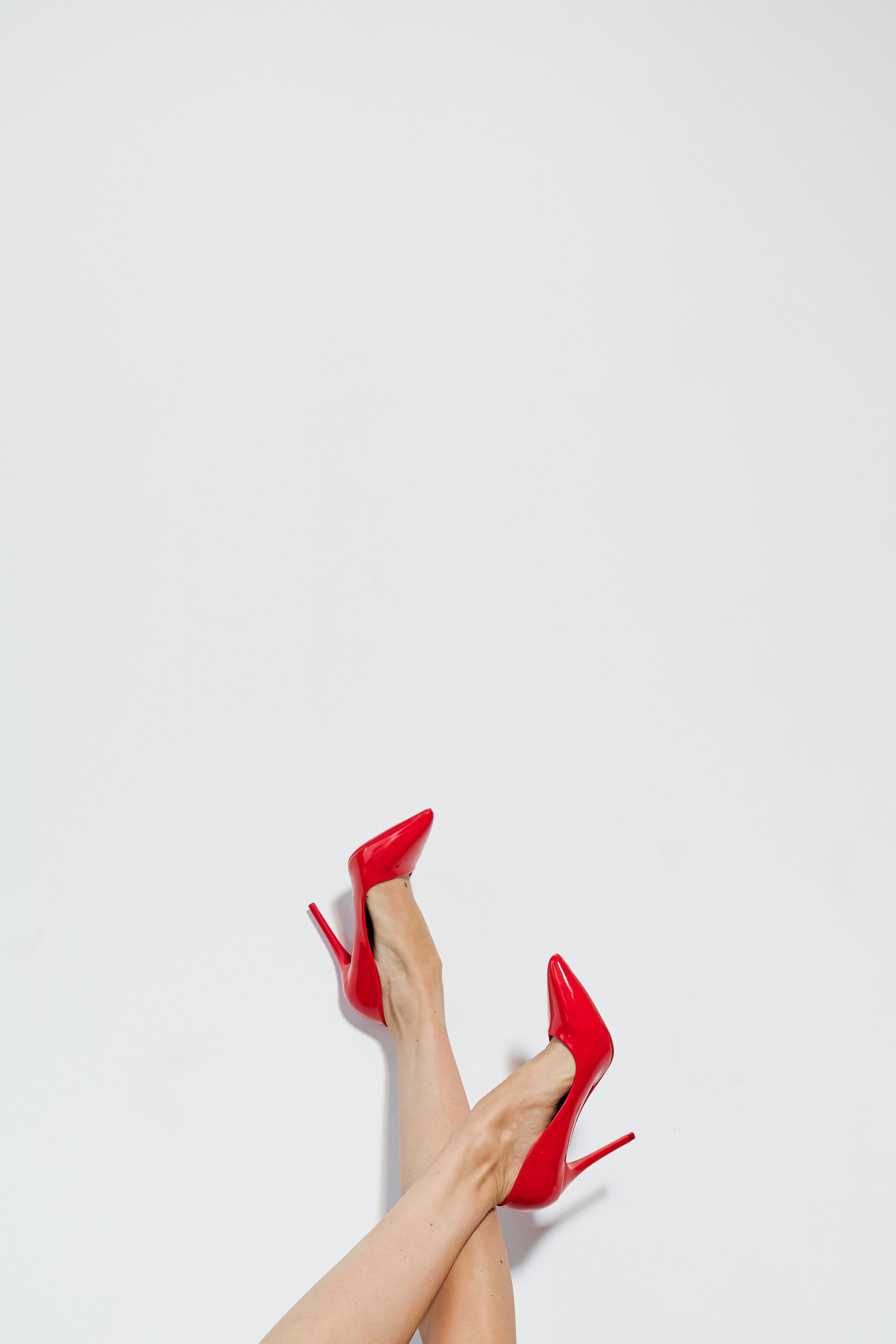 womans feet in high heeled red shoes