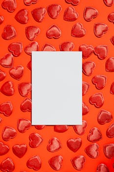 Red hearts on a vibrant backdrop with centered copyspace, perfect for Valentine's design.