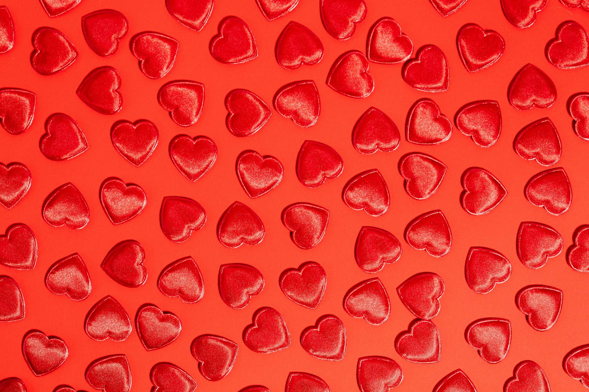 A visually striking pattern of red hearts arranged on a matching red backdrop, perfect for Valentine's promotions.