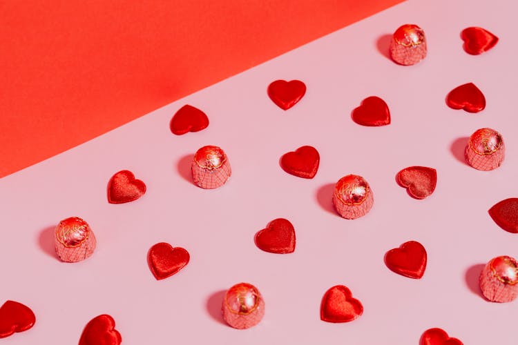 Pink And Red Diagonal Image Of Chocolates And Hearts Shapes