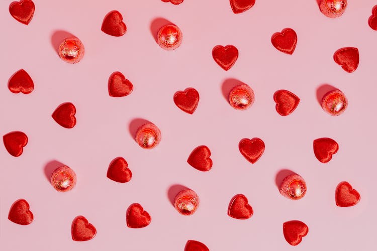 Hearts And Candy Against Pink Background