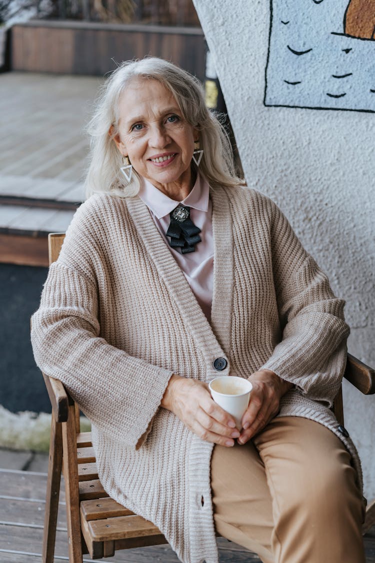 Elderly Woman Sitting While Holding Coffee