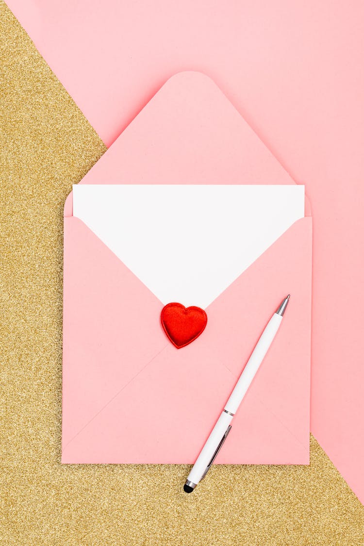 Close Up Of Pink Envelope And Pen