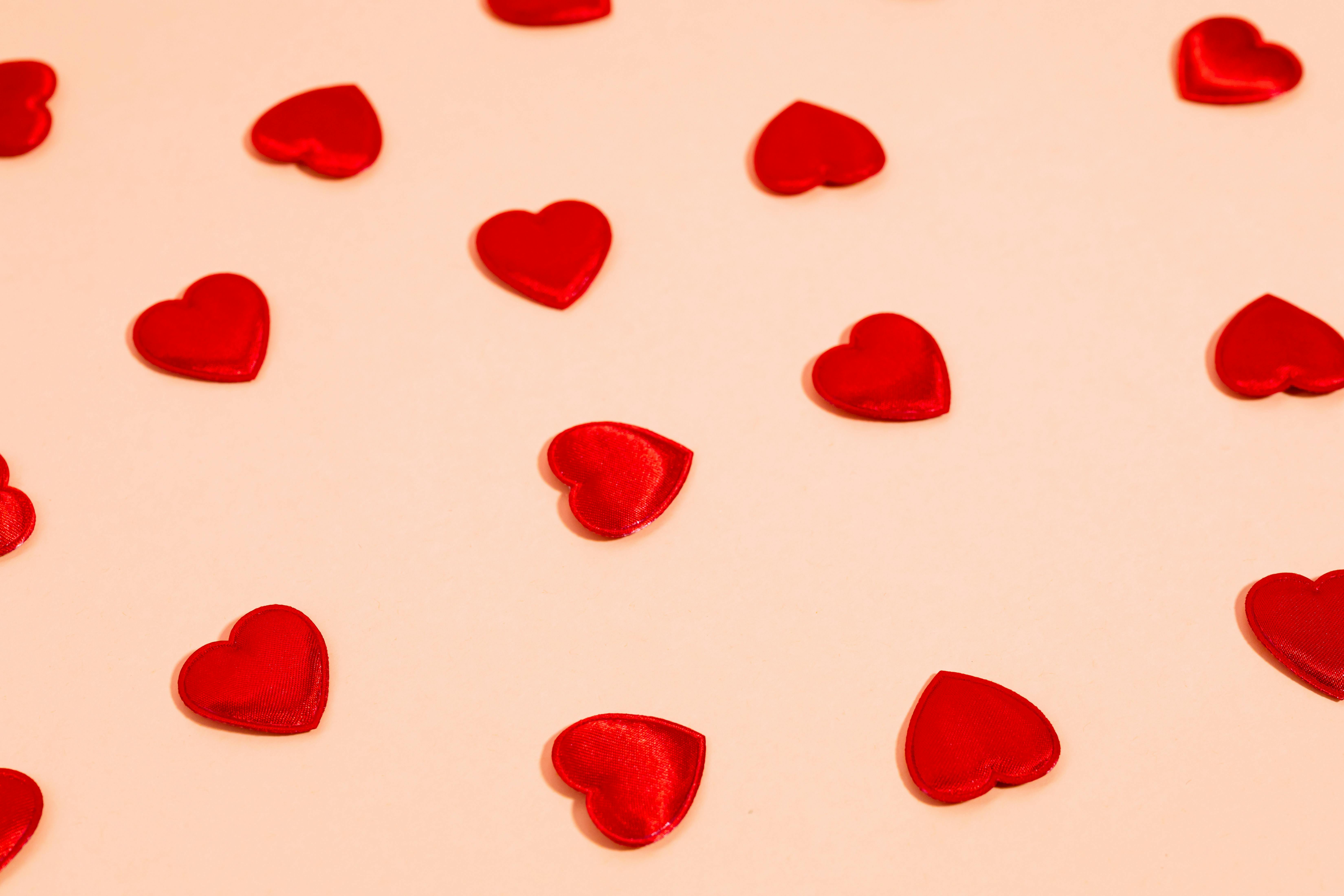 heart shaped candies on a pink background