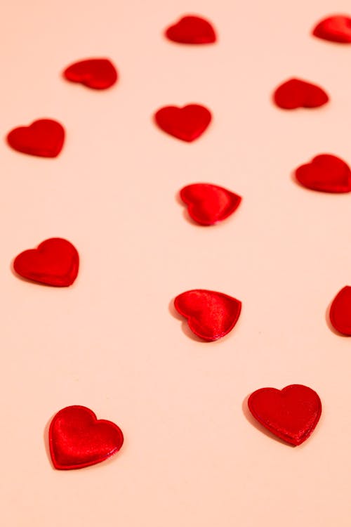Free Red Hearts Against Yellow Background Stock Photo