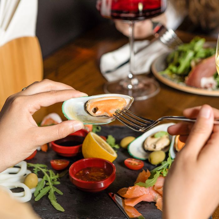 Gourmet seafood meal of mussels and salmon set for dinner, photo by Farhad Ibrahimzade on Pexels