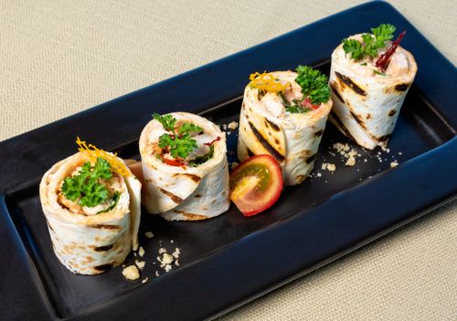 Free Appetizing gourmet wraps filled with fresh vegetables on a stylish plate. Stock Photo