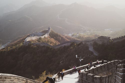 Free People Walking on the Great Wall of China on a Foggy Day Stock Photo